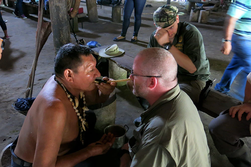 Joshua Swanagon taking part in a ceremony with a Yacuna Chief in the Amazon Jungle.