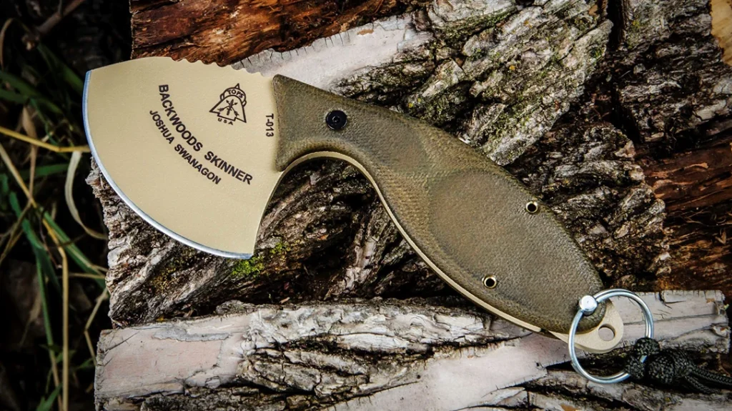 TOPS Knives Backwoods Skinner on wood.