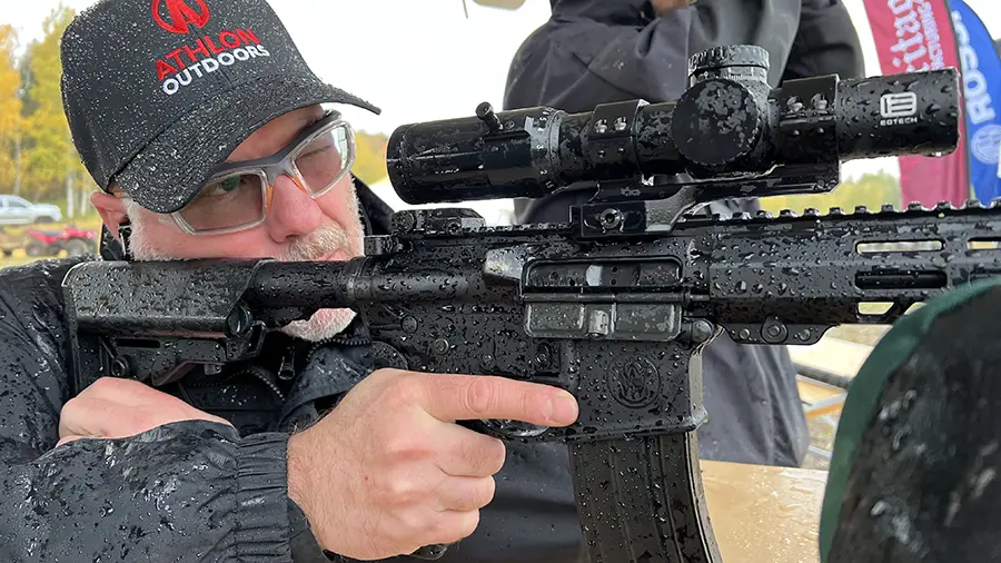 Joshua Swanagon shooting a Smith & Wesson rifle in the rain.