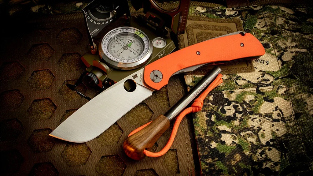 Spyderco Subvert on a backpack with a compass.